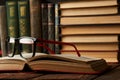 Old books and reading glasses on desk in library room Royalty Free Stock Photo