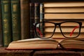 Old books and reading glasses on desk in library room Royalty Free Stock Photo
