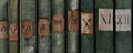 Old books with Roman numerals in the library Royalty Free Stock Photo