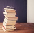 Old books row on the chalk board background Royalty Free Stock Photo