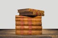 Old books shelf isolated on wooden table Royalty Free Stock Photo