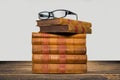 Old books shelf isolated on wooden table Royalty Free Stock Photo