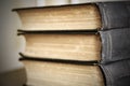 Old books are stacked close-up, binding black covers, selective focus, side view Royalty Free Stock Photo