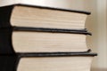 Old books are stacked close-up, black covers, selective focus, side view Royalty Free Stock Photo