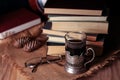 Old books and tea in the evening. A glass of drink on table. The Royalty Free Stock Photo