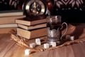 Old books and tea in the evening. A glass of drink on table. The Royalty Free Stock Photo