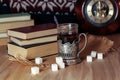 Old books and tea in the evening. A glass of drink on table. The Royalty Free Stock Photo