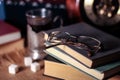 Old books and tea in the evening. A glass of drink on table. The Royalty Free Stock Photo