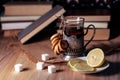 Old books and tea in the evening. A glass of drink on table. The Royalty Free Stock Photo