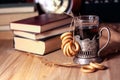 Old books and tea in the evening. A glass of drink on table. The Royalty Free Stock Photo