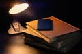 Old books and a telephone on the desk with the lamp on. Education concept Royalty Free Stock Photo