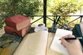 Old books with treatise, glasses and pencil on a wooden table in Royalty Free Stock Photo