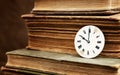 Old books and vintage clock face Royalty Free Stock Photo