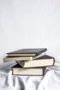 Old 4 books on white textured curtain with white background.