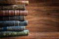 Old books on wooden desk and ray of light. Bookshelf history theme grunge background. Concept on the theme of history, nostalgia, Royalty Free Stock Photo