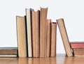 Stack of old yellowed books on a wooden shelf Royalty Free Stock Photo