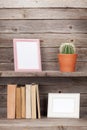 Old books and photo frames on a wooden shelf Royalty Free Stock Photo