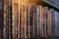 Old books on wooden shelf. Tiled Bookshelf background.  Concept on the theme of history, nostalgia, old age. Retro style. Shallow Royalty Free Stock Photo