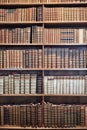 Old books on wooden shelves in The State Hall Prunksaal.