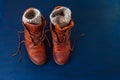 Old boot red brown shoes blue top view background leather laces high canvas dirty wool knitted warm gray socks