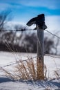 Old Boot on top of Fence Post in the Snow Royalty Free Stock Photo