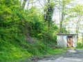 Old booth in nature. Abandoned buildings. Old barn among the trees Royalty Free Stock Photo