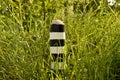 Old border post canceled border in the grass Royalty Free Stock Photo