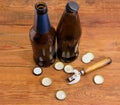 Old bottle opener, drink bottles, bottle caps on rustic table