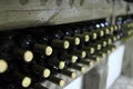 Old bottles of wine on a wooden shelf Royalty Free Stock Photo