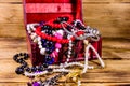 Old box of red wood full of the jewelry. Treasure chest