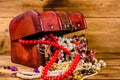 Old box of red wood full of the jewelry. Treasure chest Royalty Free Stock Photo