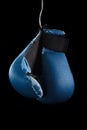 Old boxing gloves hang on nail black background Royalty Free Stock Photo
