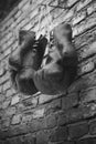 Old boxing gloves hang on nail on brick wall with copy space for text. High resolution 3d render Royalty Free Stock Photo