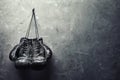 Old boxing gloves hang on nail on texture wall Royalty Free Stock Photo