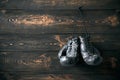 Old boxing gloves hanging on nail on wooden wall with copy space for tex Royalty Free Stock Photo