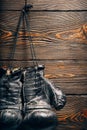 Old boxing gloves hanging on nail on wooden wall. Royalty Free Stock Photo