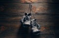 Old boxing gloves hanging on nail on wooden wall Royalty Free Stock Photo