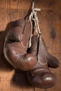 Old Boxing Gloves, hanging on wooden wall Royalty Free Stock Photo