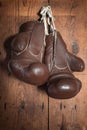 Old Boxing Gloves, hanging on wooden wall Royalty Free Stock Photo