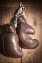 Old Boxing Gloves, hanging on wooden wall Royalty Free Stock Photo