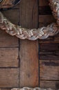 Old braided rope on the wooden deck of a sea boat