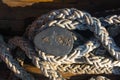 Old braided rope on the wooden deck of a sea boat