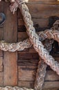 Old braided rope on the wooden deck of a sea boat