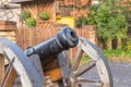 The old brass cannons in the battlefield.old metal cannons standing on two wooden supports on a grassy lawn or field Royalty Free Stock Photo