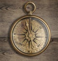 Old brass compass on wood table Royalty Free Stock Photo