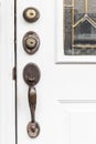 Old brass door handle and white wooden door Royalty Free Stock Photo