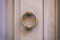 Old brass door knocker on a gray front door Royalty Free Stock Photo
