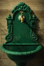 Old brass faucet on the vintage green washstand. Royalty Free Stock Photo