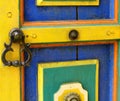 Old brass handle on colorful wooden door Royalty Free Stock Photo