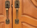 Old brass handle on wood door. Royalty Free Stock Photo